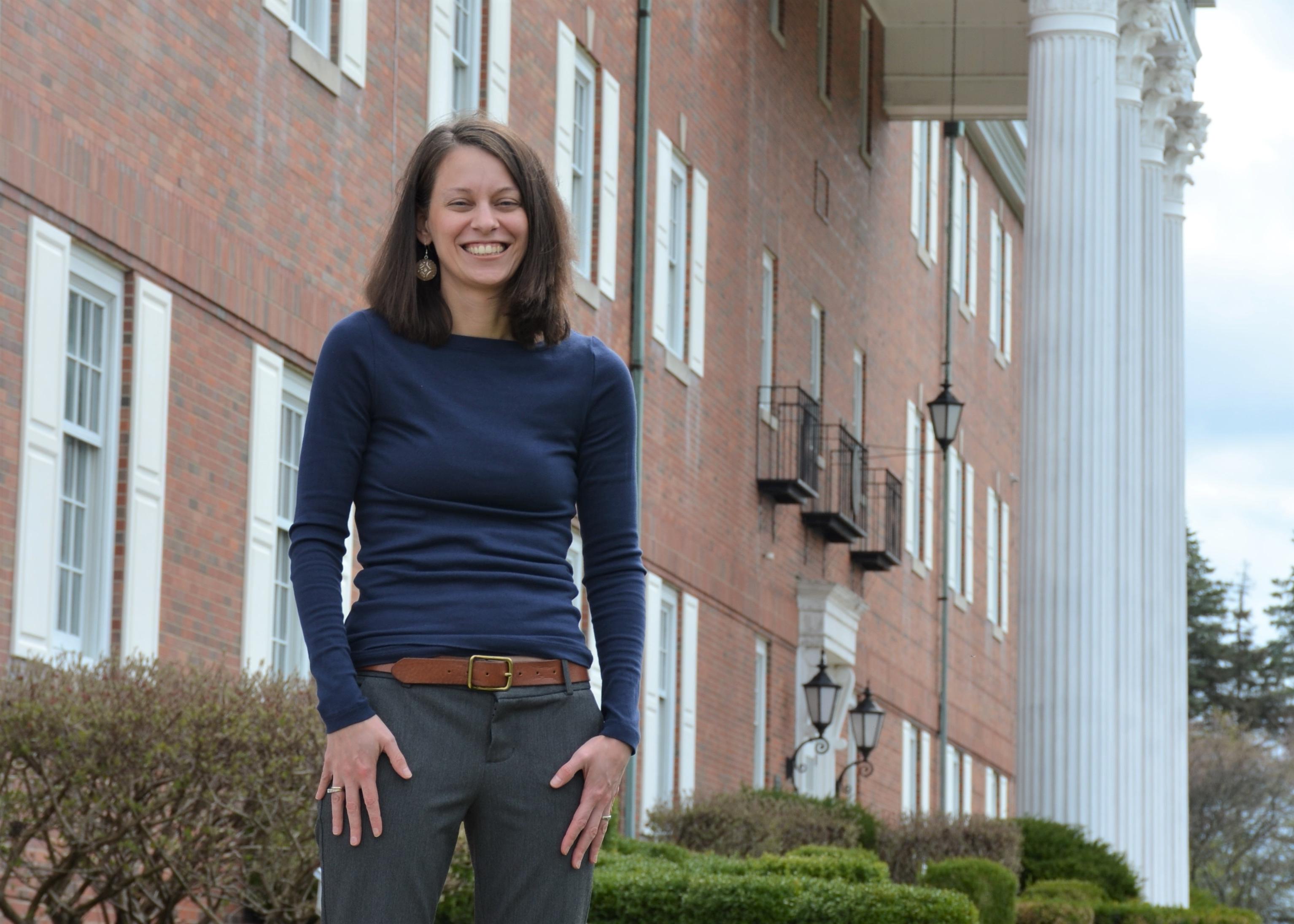 Woman standing in front of brick building